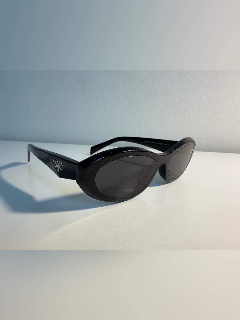 Prada Black Oval Sunglasses with Dark Lenses
